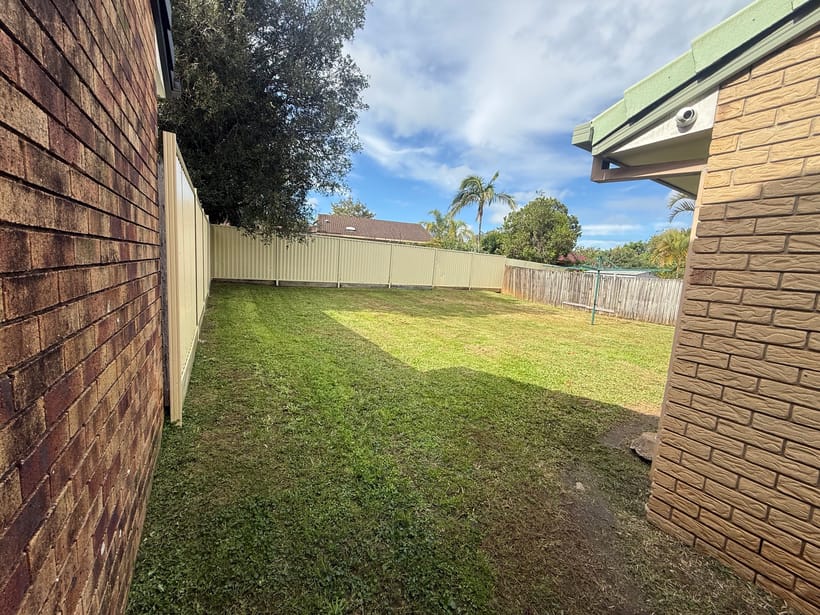 A large backyard lawn mown and tidied after a one-off clean-up