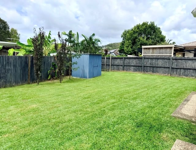 A tidy backyard with a mown lawn and garden shed